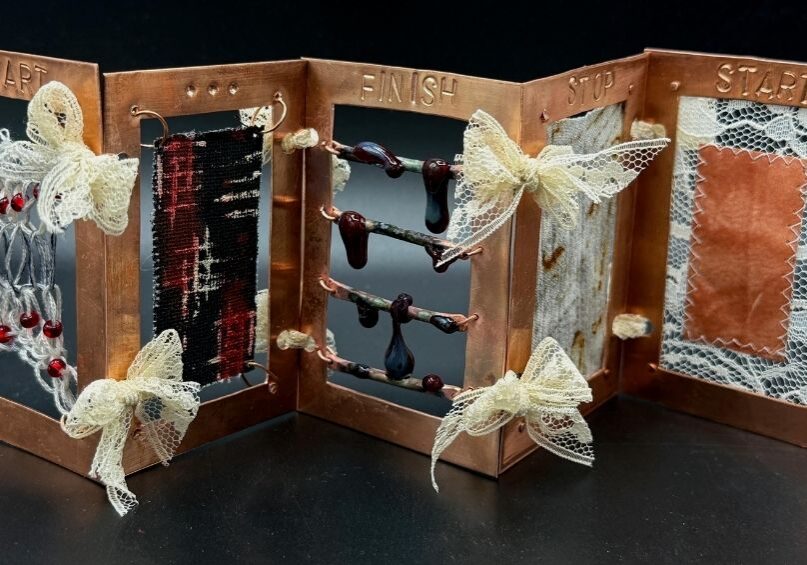 Aili Flannery’s award-winning sculpture, “Process,” was made of copper, string, copper wire, glass beads, glass, rust-stained fabric, lace, turmeric sun-printed paper, and thread. It represents “the timeline of having depression to the process of healing,” Flannery explained, and the theme is rooted in her own experiences. “‘Start’ shows up again at the end [of the piece], because I was ready to start healing and to continue living.”