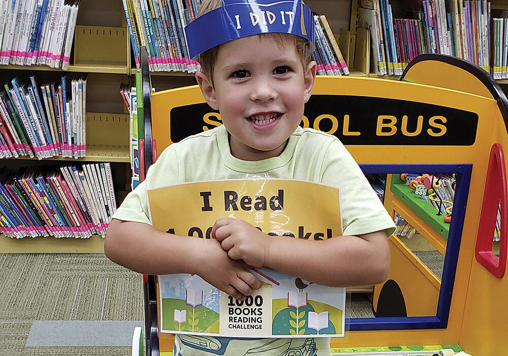 Kristina and Matthew Bailey began reading books to their son, Owen when he was six months old— they haven’t stopped.
Owen turned 4 in June and recently received an award from the Clarendon Hills Public Library for having had 1,000 books read to him before starting kindergarten.

The library’s 1,000 Books Before Kindergarten Challenge is one of a few reading challenge programs offered in Clarendon Hills, where the Bailey family has lived for the past 2 1/2 years.
Kristin Bailey said she saw an ad about the 1,000 Books Before Kindergarten Challenge and decided it was a good fit for Owen.

“He’s always been really into books,” Bailey said. “He had a natural interest in books at nine months old. That’s when COVID started, and he didn’t get out much, so reading books to him worked out very well. He’s a naturally curious kid, and imagination-building is important. The reading allows him to learn and explore new things, and he really wants to learn to read now.”

Krista Devlin, the Clarendon Hills library’s youth services librarian, said there’s a specific reason The Friends of the Library-sponsored 1,000 Books Before Kindergarten Challenge was started in 2022.

“Reading aloud to a child is one of the best ways to help develop important early literacy skills, which will prepare them for kindergarten,” Devlin said. “It is also a great way to bond with your child and to encourage a love of reading.”

Devlin said Owen was the second child to reach the challenge of having 1,000 books read to him before starting kindergarten. He was awarded a certificate, a crown, and his picture was taken to recognize his accomplishment.

Bailey, who said she is “a big reader,” said her family usually goes to the library once a week. Reading three books each night to Owen, along with a book before nap time, is the household normal.

“Consistency in our routine has been good and is important,” she said, adding that Owen’s two sisters, ages 2 1/2 and 1
