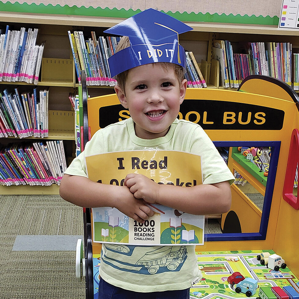 Kristina and Matthew Bailey began reading books to their son, Owen when he was six months old— they haven’t stopped.
Owen turned 4 in June and recently received an award from the Clarendon Hills Public Library for having had 1,000 books read to him before starting kindergarten.

The library’s 1,000 Books Before Kindergarten Challenge is one of a few reading challenge programs offered in Clarendon Hills, where the Bailey family has lived for the past 2 1/2 years.
Kristin Bailey said she saw an ad about the 1,000 Books Before Kindergarten Challenge and decided it was a good fit for Owen.

“He’s always been really into books,” Bailey said. “He had a natural interest in books at nine months old. That’s when COVID started, and he didn’t get out much, so reading books to him worked out very well. He’s a naturally curious kid, and imagination-building is important. The reading allows him to learn and explore new things, and he really wants to learn to read now.”

Krista Devlin, the Clarendon Hills library’s youth services librarian, said there’s a specific reason The Friends of the Library-sponsored 1,000 Books Before Kindergarten Challenge was started in 2022.

“Reading aloud to a child is one of the best ways to help develop important early literacy skills, which will prepare them for kindergarten,” Devlin said. “It is also a great way to bond with your child and to encourage a love of reading.”

Devlin said Owen was the second child to reach the challenge of having 1,000 books read to him before starting kindergarten. He was awarded a certificate, a crown, and his picture was taken to recognize his accomplishment.

Bailey, who said she is “a big reader,” said her family usually goes to the library once a week. Reading three books each night to Owen, along with a book before nap time, is the household normal.

“Consistency in our routine has been good and is important,” she said, adding that Owen’s two sisters, ages 2 1/2 and 1